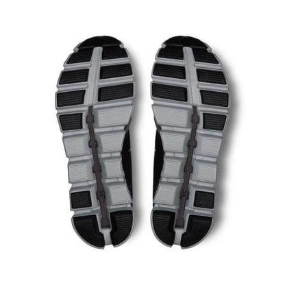 התמונה מציגה את הסוליות של זוג נעלי On Cloud 5 Push M Rock/Black 69.97739, עם עיצוב מפולח הכולל חלקים אפור כהה ואפור בהיר על רקע לבן.